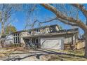 Two-story house with a large tree in front and a swing set at 5760 S Geneva St, Greenwood Village, CO 80111