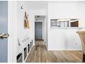 Charming entryway featuring hardwood floors, storage bench with baskets, and wall hooks for added convenience at 1263 S Gilbert St, Castle Rock, CO 80104