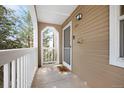 Inviting covered front porch with 'Home Sweet Home' doormat, number 1265 displayed, and a pleasant outdoor view at 1263 S Gilbert St, Castle Rock, CO 80104