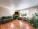 Cozy living room with a fireplace, comfortable seating, and wood-look flooring at 1120 S Waco St # A, Aurora, CO 80017
