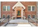 Inviting brick entryway with a detailed archway door and decorative sconces at 963 N Logan St # 2, Denver, CO 80203