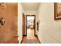 Hallway leading to living area with wood floors, textured walls, and vintage charm at 963 N Logan St # 2, Denver, CO 80203