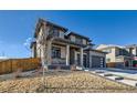 Beautiful two-story home showcasing modern architecture, gray tones, and landscaped front yard at 14209 Beebalm Loop, Parker, CO 80134