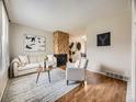 Comfortable living room showcasing hardwood floors, stone fireplace, and neutral decor at 1932 S Oswego Way, Aurora, CO 80014