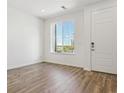 Bright entryway with beautiful wood-look floors and a large window at 6902 Huddersfield Ln, Castle Pines, CO 80108