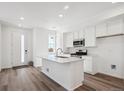 Bright kitchen boasts a center island, modern stainless appliances, and a sleek design at 1368 Penner Dr, Erie, CO 80026