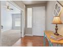 Welcoming entryway with wood floors, a console table, and an open doorway to the living area at 3727 Starry Night Loop, Castle Rock, CO 80109