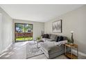 Bright living room featuring an expansive sliding glass door and cozy furniture with backyard views at 4274 S Salida Way # 6, Aurora, CO 80013