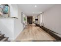 Finished basement area showcasing an exercise bike and hardwood floors at 7869 S Turkey Creek Rd, Morrison, CO 80465