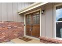 Inviting front entrance with double doors, brick accents, a 'welcome' mat, and stylish exterior lighting at 10694 E Dorado Ave, Englewood, CO 80111
