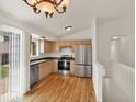 Well-lit kitchen features stainless steel appliances, wood floors, and ample cabinet space at 5280 E 128Th Way, Thornton, CO 80241