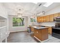 Well-lit kitchen with stainless steel appliances, center island, and hardwood floors at 10535 Holyoke Dr, Parker, CO 80134