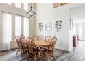 Inviting dining area with wood table and chairs, chandelier, and lots of natural light at 1280 Galactic Pl, Castle Rock, CO 80108