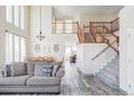 Spacious living area featuring a staircase, wood flooring, and lots of natural light at 1280 Galactic Pl, Castle Rock, CO 80108