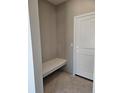 Mudroom featuring a built-in bench and a white door, creating a clean and functional space at 6071 Caribou Dr, Brighton, CO 80601