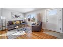 Bright living room with hardwood floors, gray sofa, and modern decor at 1708 Oswego St, Aurora, CO 80010