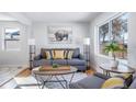 Comfortable living room featuring a large window and stylish gray sofa at 1708 Oswego St, Aurora, CO 80010