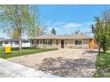 A quaint home with an inviting front yard and a driveway for parking at 6528 S Louthan St, Littleton, CO 80120