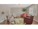 Cozy living room with designer chairs, rug, and lighting on hardwood floors at 6528 S Louthan St, Littleton, CO 80120