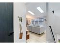 Bright living room with skylights and view of dining area at 11420 E 1St Ave, Aurora, CO 80010
