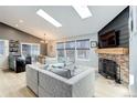 Open-concept living room with fireplace and large windows at 11420 E 1St Ave, Aurora, CO 80010