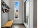 Modern entryway featuring a wooden bench and storage rack with a view of the outside at 3444 Navajo St # 10, Denver, CO 80211