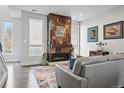 Comfortable living room features a unique fireplace, large windows and modern décor at 3444 Navajo St # 10, Denver, CO 80211