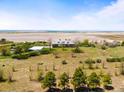 Aerial view of brick house and large lot with surrounding farmland and blue sky at 4100 Eclectic St, Watkins, CO 80137