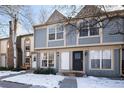 Two-story townhome with gray siding and brick chimney at 1711 S Blackhawk Way # D, Aurora, CO 80012