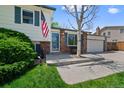Inviting entryway featuring a brick facade, bench seating, and manicured landscaping at 4525 S Cole Ct, Morrison, CO 80465