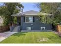 Charming home with a well-maintained lawn and inviting front porch at 1765 Xenia St, Denver, CO 80220