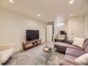 Cozy living area features plush seating, glass coffee table, and neutral tones at 1374 N Ogden St # C, Denver, CO 80218