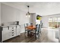 A cozy dining area featuring a table with seating for four and stylish lighting fixtures at 3471 S Ammons St # 12-6, Lakewood, CO 80227