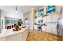 Bright kitchen boasts granite countertops, stainless steel appliances, and an open layout perfect for entertaining at 5280 Longs Peak St, Brighton, CO 80601