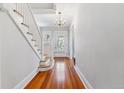 Bright foyer with hardwood floors, staircase, and elegant chandelier at 761 N Lafayette St, Denver, CO 80218