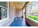 Inviting front porch features blue painted floors, brick siding, and room to relax at 761 N Lafayette St, Denver, CO 80218