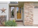 Inviting front door framed by brick and a decorative star, enhancing the home's curb appeal at 2871 Humboldt Cir, Longmont, CO 80503