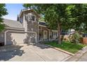 Charming two-story home with a well-maintained front yard, an attached garage, and mature shade trees at 8060 Meadowdale Sq, Niwot, CO 80503