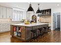 Spacious kitchen boasts a large island, stylish pendant lighting, stainless steel appliances, and ample counter space at 2500 S Clayton St, Denver, CO 80210