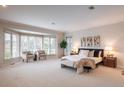 Bright main bedroom with a large bay window and sitting area and views to the outdoors at 101 Glenmoor Ln, Cherry Hills Village, CO 80113