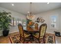 Elegant dining room featuring a chandelier, detailed chairs, and a decorative rug at 1366 Killington Ct, Evergreen, CO 80439