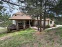 Beautiful home exterior surrounded by mature trees, offering a serene and private setting at 1366 Killington Ct, Evergreen, CO 80439