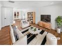 Bright living room with contemporary decor, hardwood floors, and a large, decorative striped rug at 1479 S Bellaire St, Denver, CO 80222