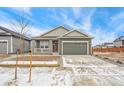 Inviting single-Gathering home featuring a two-car garage and covered front porch at 1595 Orchard St, Brighton, CO 80601