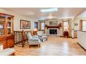 Cozy living room featuring hardwood floors, a brick fireplace, and plenty of natural light at 20855 E Lyttle Dr, Parker, CO 80138