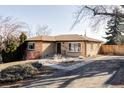 A well-maintained single-story home featuring a brick facade and a neatly landscaped yard at 3520 Miller St, Wheat Ridge, CO 80033