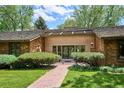 Inviting front entrance with brick pathway and manicured landscaping leading to double doors at 5196 S Williams Dr, Greenwood Village, CO 80121
