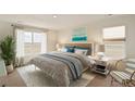 Bright bedroom with a queen-size bed and large window at 2243 Crosswind St, Fort Lupton, CO 80621
