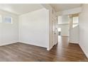 Bright hallway with wood flooring leading to other rooms at 2243 Crosswind St, Fort Lupton, CO 80621