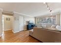 Cozy living room with a large window offering natural light, complemented by a comfortable sofa and hardwood floors at 10 N Ogden St # 101, Denver, CO 80218